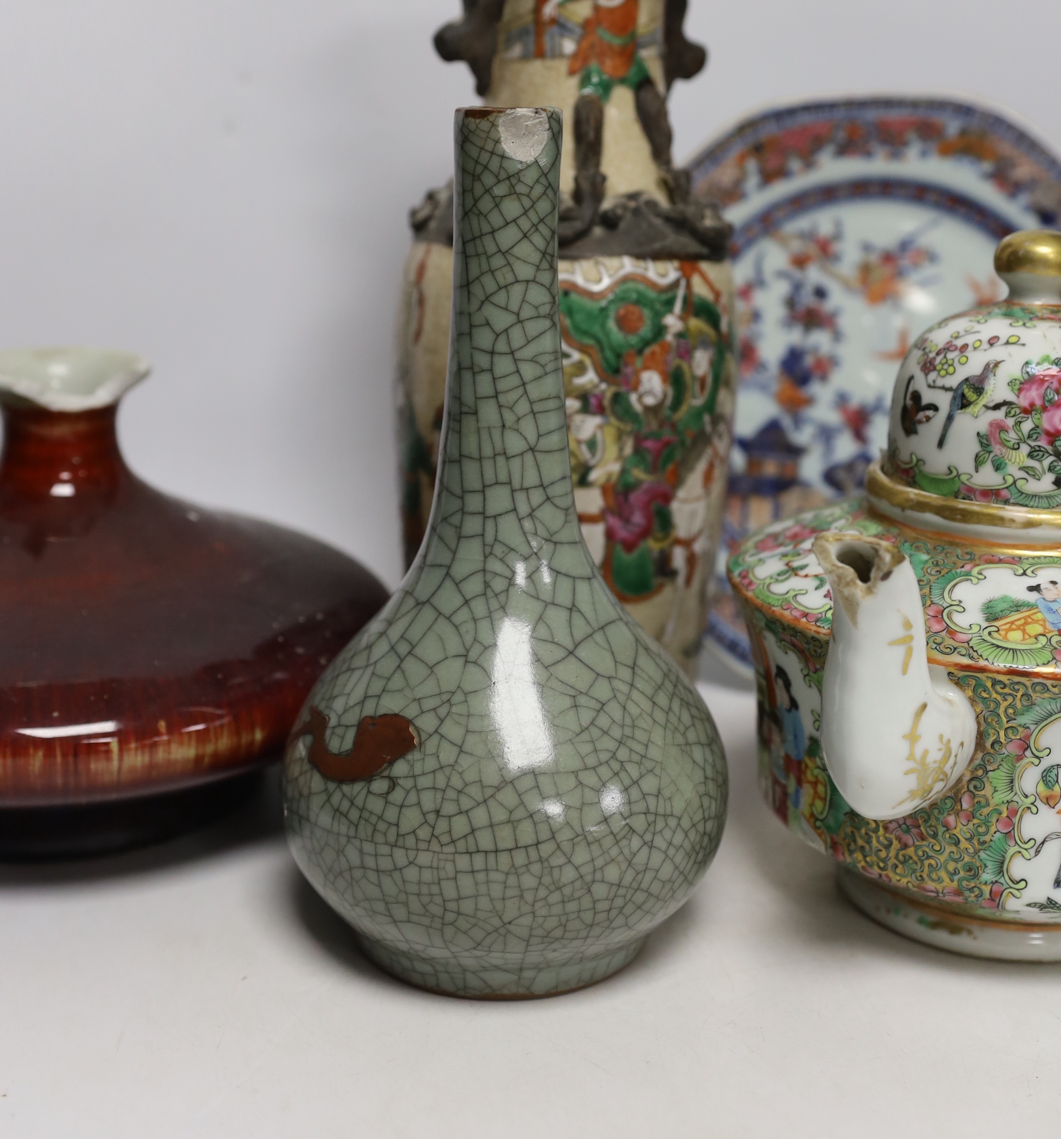 An 18th century Chinese export dish, a sang de boeuf squat vase, a crackle glaze bottle vase and a famille rose teapot, tallest 23cm